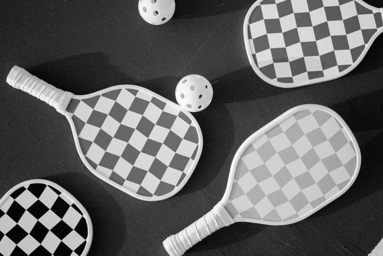 Pickleballs and paddles on a dark background